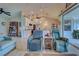 Spacious open-concept living area with kitchen in background and access to screened porch at 587 Viridian St, Englewood, FL 34223