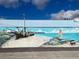 Colorful outdoor mural depicting a shipwrecked pirate ship with a mermaid on a sunny beach at 587 Viridian St, Englewood, FL 34223