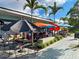 Outdoor cafe with colorful umbrellas providing shade over tables, creating a vibrant dining atmosphere at 587 Viridian St, Englewood, FL 34223