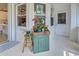 Bright sunroom with unique cabinet and stained-glass window accents, creating a welcoming atmosphere at 587 Viridian St, Englewood, FL 34223