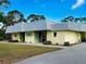 Exterior of the Lemon Bay Playhouse with a covered entrance and landscaping at 587 Viridian St, Englewood, FL 34223