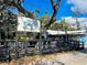 Outdoor seating area at the Blue Pineapple Bistro under a large tree with hanging lights at 587 Viridian St, Englewood, FL 34223