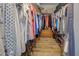 Organized walk-in closet with wooden floors, shelving, and hanging storage for ample space at 587 Viridian St, Englewood, FL 34223