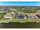 Aerial view features backyard pools, a private dock, boat, a spacious screened lanai, and waterfront access at 8144 Antwerp Cir, Port Charlotte, FL 33981