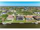 An aerial view of the waterfront property highlighting the backyard with a screened lanai, pool, and private dock on the canal at 8144 Antwerp Cir, Port Charlotte, FL 33981