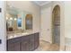 Elegant bathroom boasts granite countertops, a large vanity, and a walk-in shower with custom tile work at 8144 Antwerp Cir, Port Charlotte, FL 33981