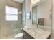 Bathroom featuring a glass shower, a marbled granite countertop, and decorative mosaic tiling at 8144 Antwerp Cir, Port Charlotte, FL 33981