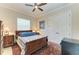 Bedroom boasts a ceiling fan, a large window, and a charming antique bed and rug at 8144 Antwerp Cir, Port Charlotte, FL 33981