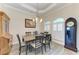 Formal dining room with stylish chairs, an elegant chandelier, and natural light from arched windows at 8144 Antwerp Cir, Port Charlotte, FL 33981