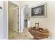 Home entryway featuring a decorative table and mirror and opening into the kitchen area at 8144 Antwerp Cir, Port Charlotte, FL 33981