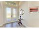 Bright foyer showcasing a decorative table, mirror, and a glimpse of the home's interior at 8144 Antwerp Cir, Port Charlotte, FL 33981