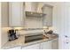 Kitchen featuring granite countertops, tile backsplash, and modern appliances at 8144 Antwerp Cir, Port Charlotte, FL 33981