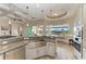 Bright kitchen with granite countertops, stainless steel appliances, and a view of the water at 8144 Antwerp Cir, Port Charlotte, FL 33981