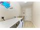 Well-lit laundry room with modern appliances and a convenient folding area at 8144 Antwerp Cir, Port Charlotte, FL 33981