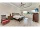 Spacious main bedroom with wood-look tile, a tray ceiling, and a large window at 8144 Antwerp Cir, Port Charlotte, FL 33981