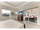 Bright main bedroom offers private access to the lanai, featuring a large TV and beautiful outdoor views at 8144 Antwerp Cir, Port Charlotte, FL 33981
