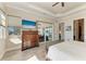 Elegant main bedroom features a large dresser, TV, and patio door access to the lanai at 8144 Antwerp Cir, Port Charlotte, FL 33981