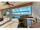 Screened lanai featuring an outdoor kitchen with granite countertops, refrigerator, and a sink overlooking the pool and waterway at 8144 Antwerp Cir, Port Charlotte, FL 33981