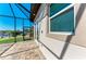 Covered patio with stone flooring, showing access door to the outside and outdoor shower at 8144 Antwerp Cir, Port Charlotte, FL 33981