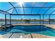 Screened pool and patio area looks out onto the canal at 8144 Antwerp Cir, Port Charlotte, FL 33981