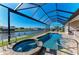 Screened-in pool and spa combination with a canal view at 8144 Antwerp Cir, Port Charlotte, FL 33981