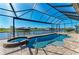 A screened pool area with integrated spa has a fantastic view of the adjacent canal at 8144 Antwerp Cir, Port Charlotte, FL 33981