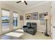 A bright sitting room has neutral tile floors and patio doors overlooking a canal, and comfortable seating at 8144 Antwerp Cir, Port Charlotte, FL 33981