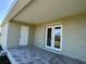 Back porch with brick floor, doors leading into house and the back yard at 9172 Ravel St, Port Charlotte, FL 33981