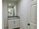 Bathroom featuring a single sink, granite countertop and large mirror at 9172 Ravel St, Port Charlotte, FL 33981