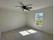 Bright bedroom featuring a ceiling fan and bright window with tile floor at 9172 Ravel St, Port Charlotte, FL 33981