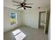 Bedroom with window, ceiling fan, and closet with tiled floors at 9172 Ravel St, Port Charlotte, FL 33981