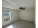 Bedroom with natural light, featuring a ceiling fan and bright window at 9172 Ravel St, Port Charlotte, FL 33981