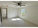 Bright bedroom featuring a window, ceiling fan, and closet with tiled floor at 9172 Ravel St, Port Charlotte, FL 33981