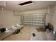 Spacious garage interior with roll up door, offering potential for customization or storage at 9172 Ravel St, Port Charlotte, FL 33981