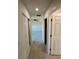 Hallway with closet leading into room with ceiling fan and natural light at 9172 Ravel St, Port Charlotte, FL 33981