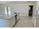 Bright kitchen featuring granite countertops, stainless steel dishwasher, and white cabinetry at 9172 Ravel St, Port Charlotte, FL 33981