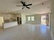 Bright, open concept living room and kitchen with tile flooring, high ceilings and natural light at 9172 Ravel St, Port Charlotte, FL 33981