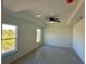 Bright and airy main bedroom features a trey ceiling, ceiling fan, and dual windows providing natural light at 9172 Ravel St, Port Charlotte, FL 33981