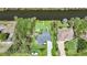 Aerial view showcasing the property's expansive yard, canal access, and proximity to lush greenery at 9350 Prospect Ave, Englewood, FL 34224