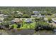 An aerial view showing the property near the water with dock and beautiful landscaping at 9350 Prospect Ave, Englewood, FL 34224