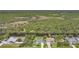 Aerial view of properties along canal, surrounded by trees and verdant landscape at 9350 Prospect Ave, Englewood, FL 34224