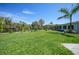 Expansive backyard with manicured lawn, privacy fence, and partial views of the home's rear facade at 9350 Prospect Ave, Englewood, FL 34224