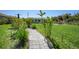 A backyard featuring a walkway path leading to the house and a spacious lawn area at 9350 Prospect Ave, Englewood, FL 34224