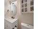 Bathroom featuring a oval mirror and a white vanity with a marble countertop at 9350 Prospect Ave, Englewood, FL 34224