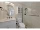 Bright bathroom featuring a marble countertop, oval mirror and shower with glass enclosure at 9350 Prospect Ave, Englewood, FL 34224