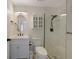 Well-lit bathroom featuring marble tiling in shower, modern vanity, and fixtures at 9350 Prospect Ave, Englewood, FL 34224