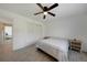Bright bedroom with a ceiling fan, white walls, and light-colored tile floors at 9350 Prospect Ave, Englewood, FL 34224