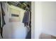 A storage closet with shelves, a hanging bar, and a safe mounted inside at 9350 Prospect Ave, Englewood, FL 34224