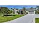 Charming single-story home with a well-manicured lawn and a lengthy gray driveway at 9350 Prospect Ave, Englewood, FL 34224