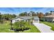 Well-kept single-story home with a manicured lawn and a fresh, gray driveway at 9350 Prospect Ave, Englewood, FL 34224